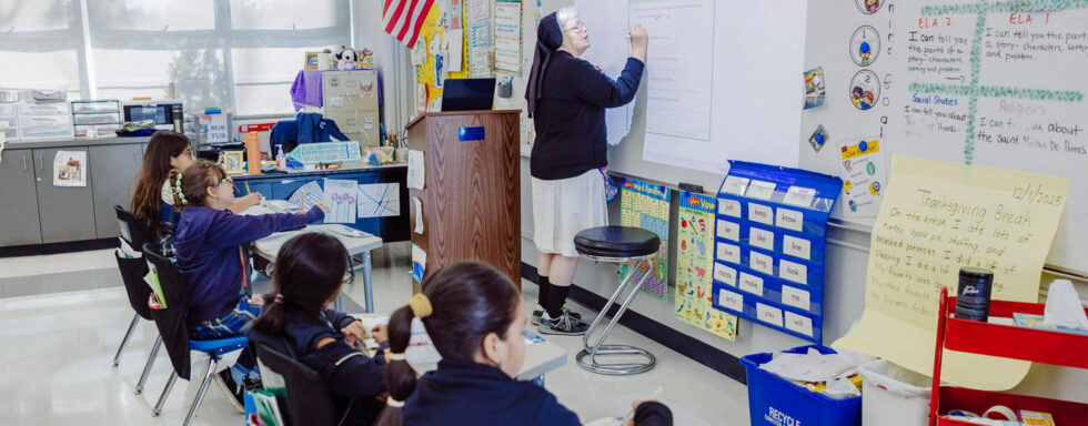St. Ignatius teacher writing on board